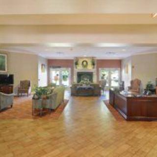A spacious and elegant lobby with comfortable seating and a reception desk.