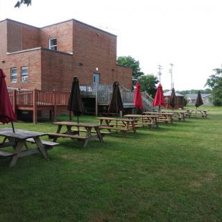 Outdoor picnic area with tables and umbrellas, perfect for enjoying a meal in the park.
