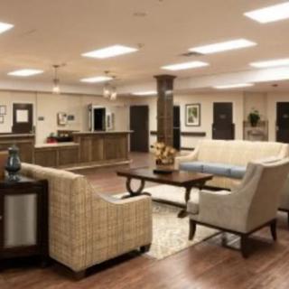A modern lobby with comfortable seating and a reception desk.