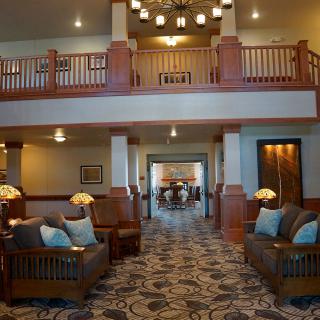 A spacious and elegantly designed hotel lobby featuring comfortable seating and stylish lighting.