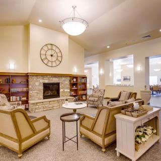 A cozy living room with a fireplace, comfortable seating, and elegant decor.
