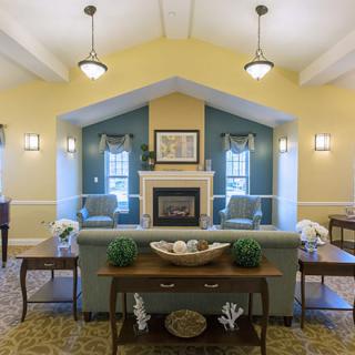 A cozy living room with a fireplace and traditional decor.