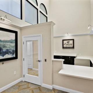 Modern office reception area with artwork and large windows.