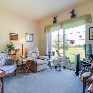 A cozy living room with comfortable seating and large windows letting in natural light.