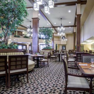 Spacious restaurant interior with elegant lighting and comfortable seating.