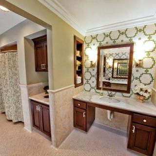 Elegant bathroom with a large vanity mirror and stylish cabinetry.