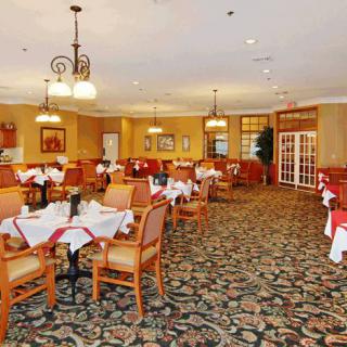 An elegant restaurant dining room with neatly arranged tables and chairs.