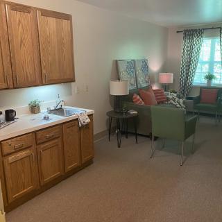 A cozy living space with a kitchenette and comfortable seating area.