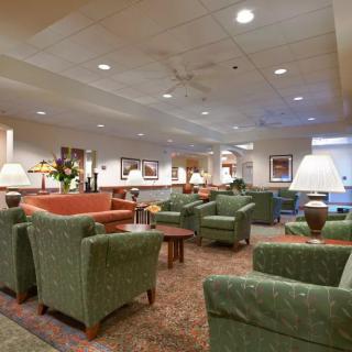 A comfortable lobby area with armchairs, sofas, and warm lighting.