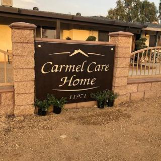 Sign for Carmel Care Home outside a residential building.