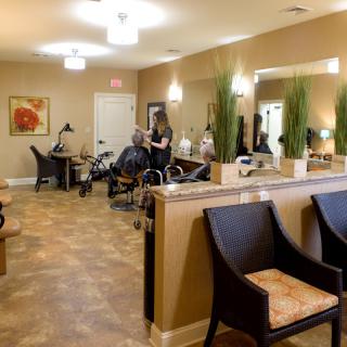 A modern salon interior with styling stations, mirrors, and a welcoming waiting area.