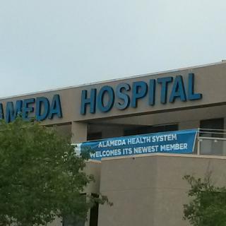 Exterior view of a hospital building with signage.