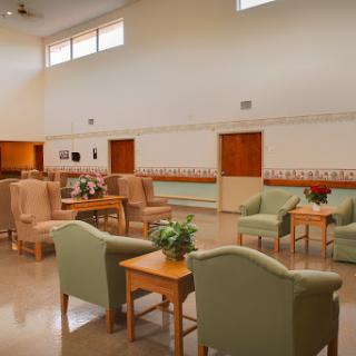 A spacious and welcoming lounge area featuring comfortable seating and natural light.