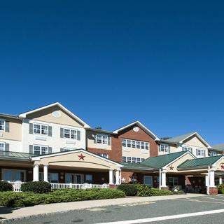 A large residential building with a clear blue sky in the background.