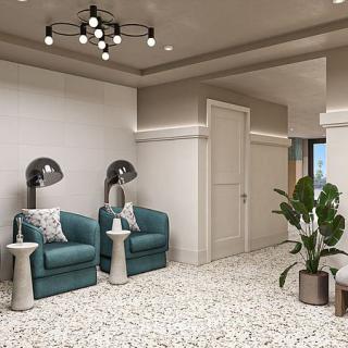 A modern waiting area with comfortable seating, stylish lighting, and decorative plants.