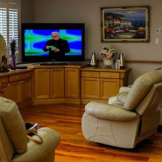 Cozy living room with recliner chairs and a television.