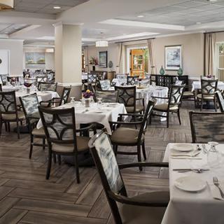 An elegant restaurant dining area set with tables and chairs, ready for guests.