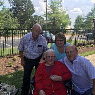 A joyful moment shared among family members, celebrating together outdoors.