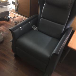 A comfortable leather recliner situated in a cozy room.