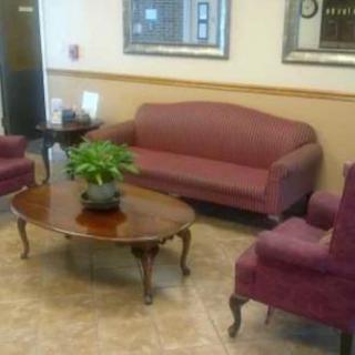 A cozy lobby waiting area with comfortable seating and a coffee table.