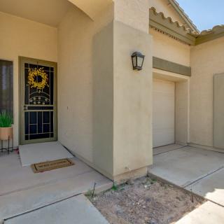 A view of a house entrance with a decorative door and exterior lighting.