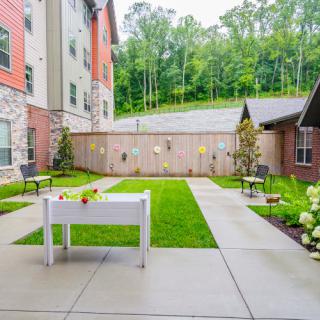 A well-maintained courtyard with a pathway and greenery, surrounded by buildings.