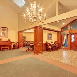 Luxurious lobby with elegant chandelier and comfortable seating.