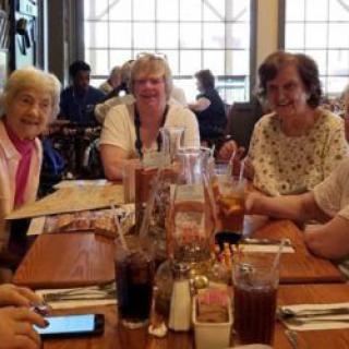 A group of women enjoying a meal together at a restaurant.