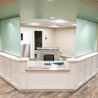 A modern reception area featuring a sleek design with green accents.