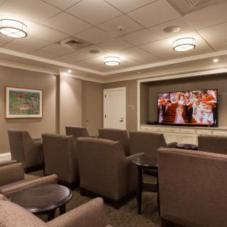 Cozy home theater setup with comfortable seating and a large TV.