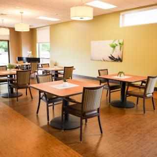 A spacious and modern dining area with contemporary furniture and natural light.
