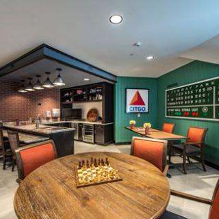 A modern game room featuring a chess board, bar seating, and stylish decor.