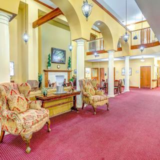 A luxurious lobby featuring elegant armchairs, archways, and decorative lighting.