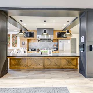 Modern kitchen with wooden accents and stainless steel appliances.