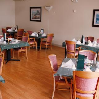 A cozy dining area featuring neatly arranged tables and chairs in a restaurant setting.