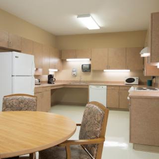 A well-organized kitchen featuring modern appliances and a dining table.