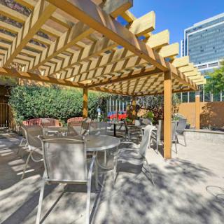 A cozy outdoor seating area shaded by a beautifully designed pergola, perfect for enjoying sunny days.
