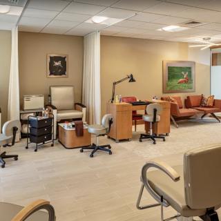 A spacious and modern nail salon interior featuring pedicure stations and a comfortable waiting area.