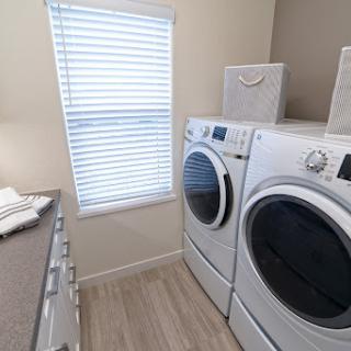 A modern laundry room featuring a washer and dryer with ample natural light.