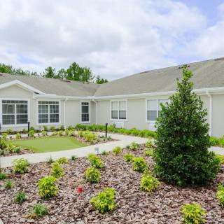 A residential house with a landscaped garden in the foreground.
