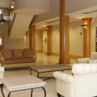 A spacious lobby area featuring elegant sofas, chairs, and tables.