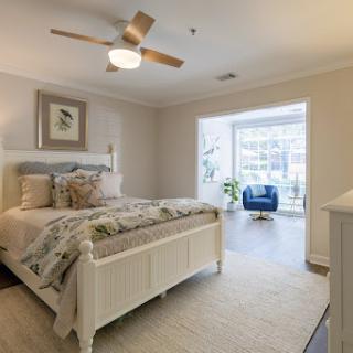 A beautifully designed bedroom featuring modern furnishings and plenty of natural light.