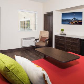 A modern hotel room featuring stylish furniture and a cozy atmosphere.