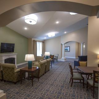 A spacious and well-lit living room with comfortable seating and modern decor.