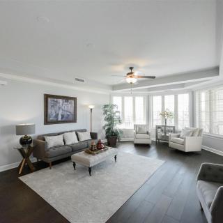 A modern living room with elegant furnishings and large windows.