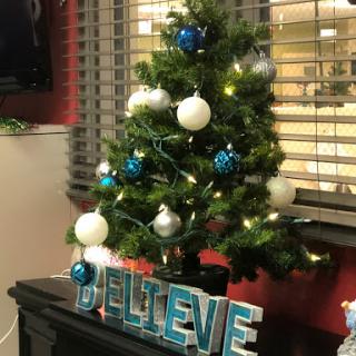 A beautifully decorated Christmas tree with blue and white ornaments, spreading holiday cheer.