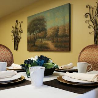 A beautifully arranged dining table with an artistic backdrop, perfect for a cozy gathering.