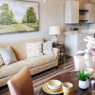 A beautifully designed living space featuring a cozy sofa and a modern dining area.
