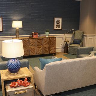 A cozy living room with a sofa, lamps, and stylish decor.