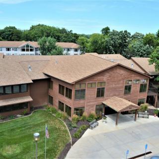 Aerial view of a brick building surrounded by greenery.